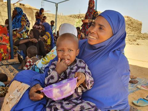 Child eating a nutritionally-dense meal at a Positive Deviance Hearth site in Niger